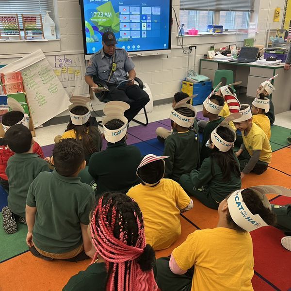Officer reading to students.